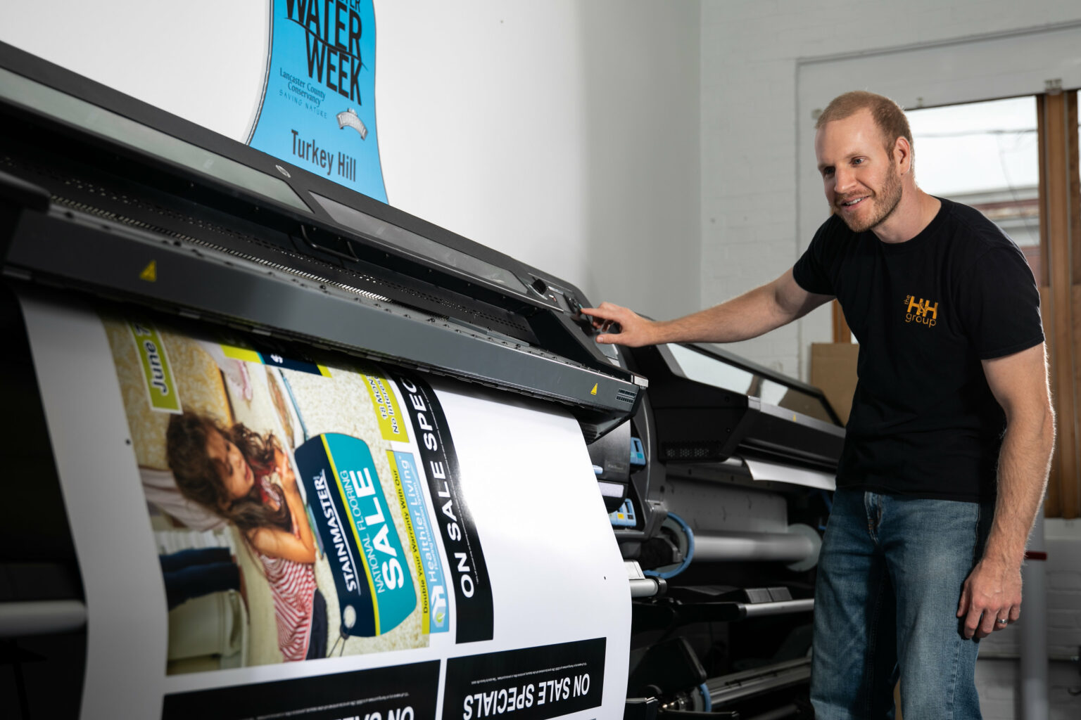 An employee from The H&H Group prints promotional flyers.