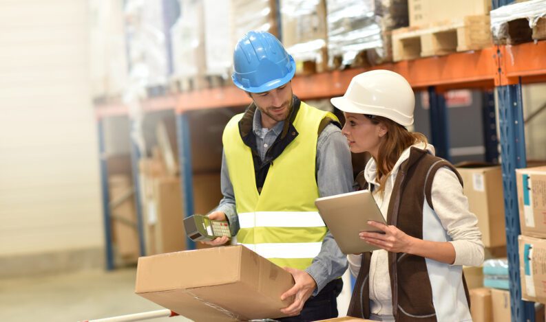 A store manager and an order selector review an order and check inventory levels.
