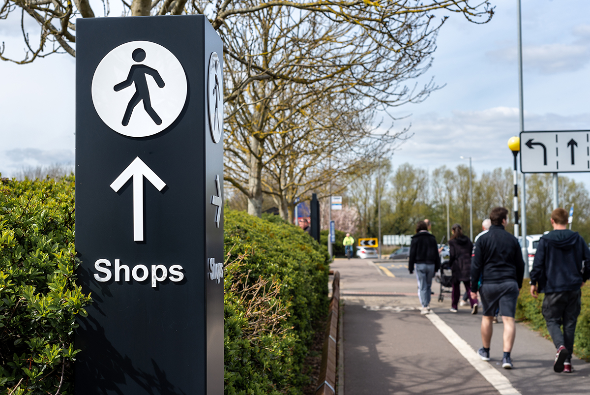 wayfinding signage that directs the viewer to a shopping center ahead